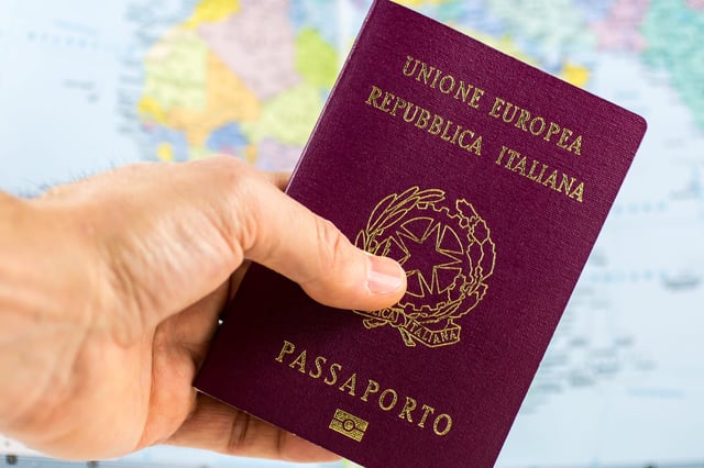 A Hand Holding Italian Passport