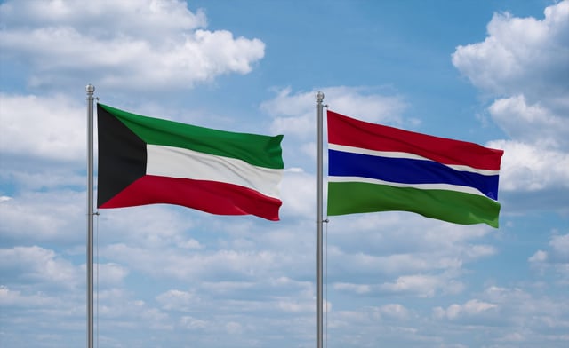Gambia And Kuwait Flags Waving Together On Blue Cloudy Sky