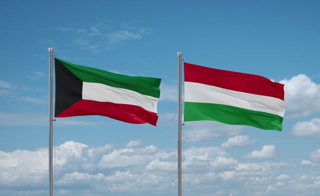 Hungary And Kuwait Flags Waving Together On Blue