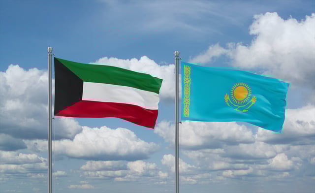 Kazakhstan And Kuwait Flags Waving Together In The Wind On Blue Cloudy Sky