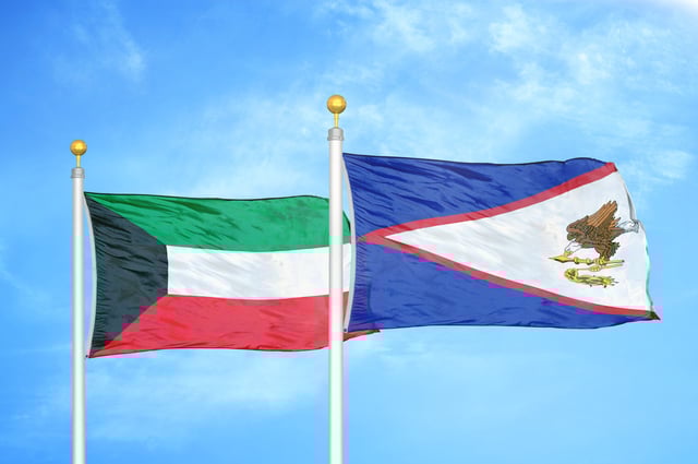 Kuwait And American Samoa Two Flags On Flagpoles And Blue Cloudy