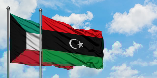Kuwait And Libya Flag Waving In The Wind Against
