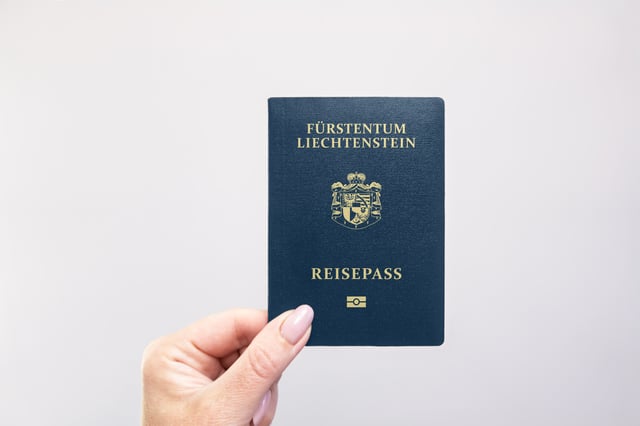 Liechtenstein Passport Held In Hand Against