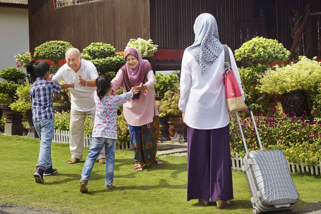 Senior Couple Greeting Family Members In Kuwait