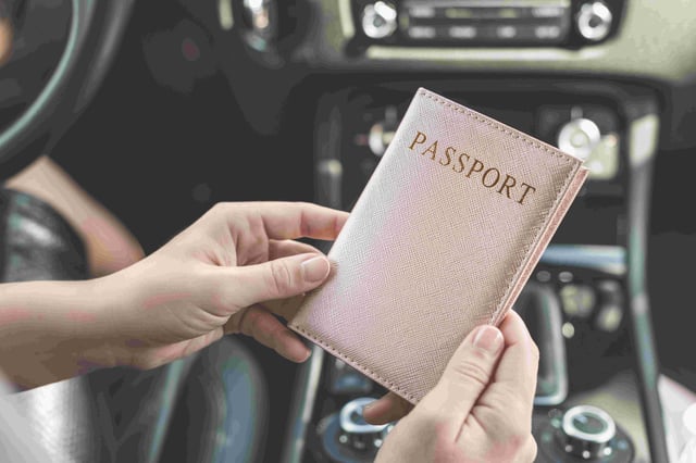 Woman Holding Passport In A Pink Cover