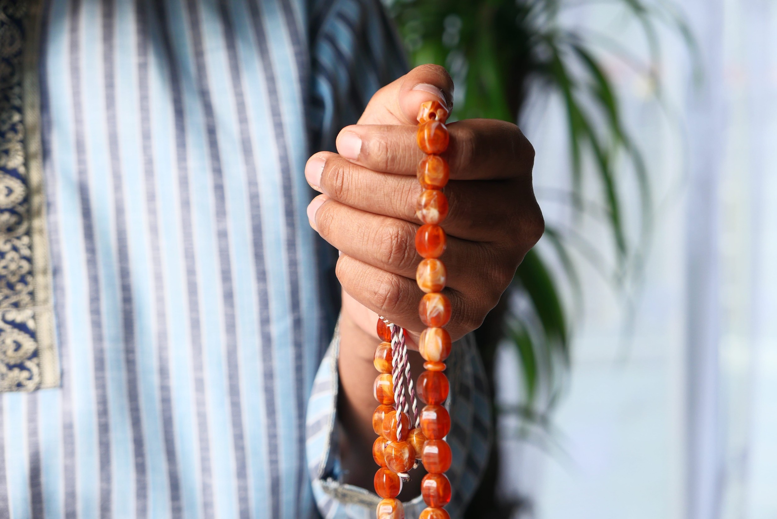 A Man Holding Misbaha Beads
