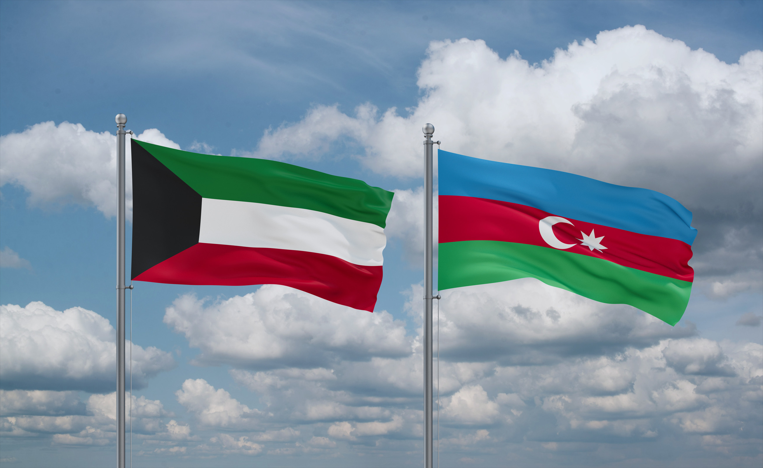Azerbaijan And Kuwait Flags Waving Together In The Wind On Blue Cloudy Sky