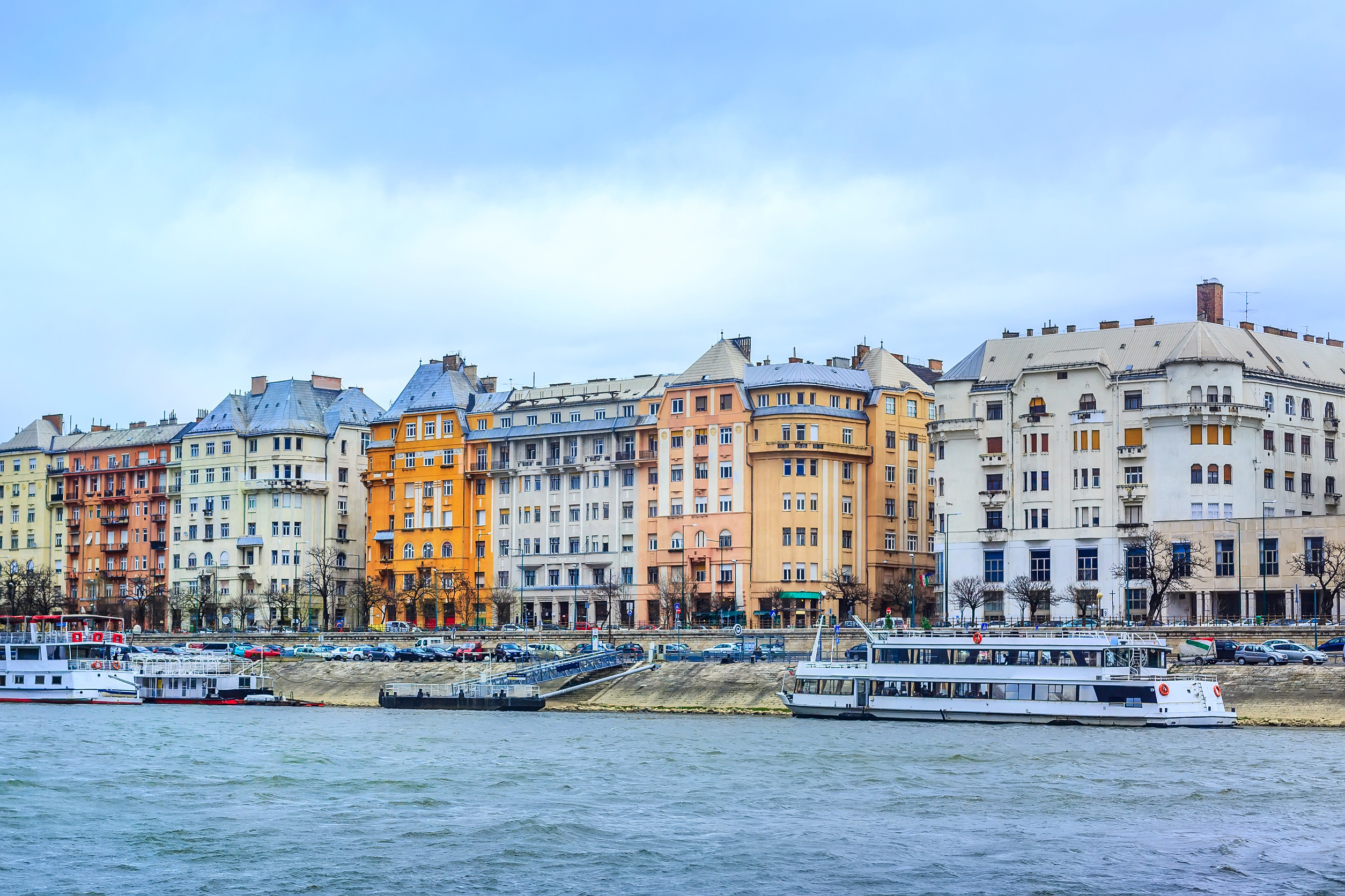 budapest hungary danube river bank with colorful houses and boats