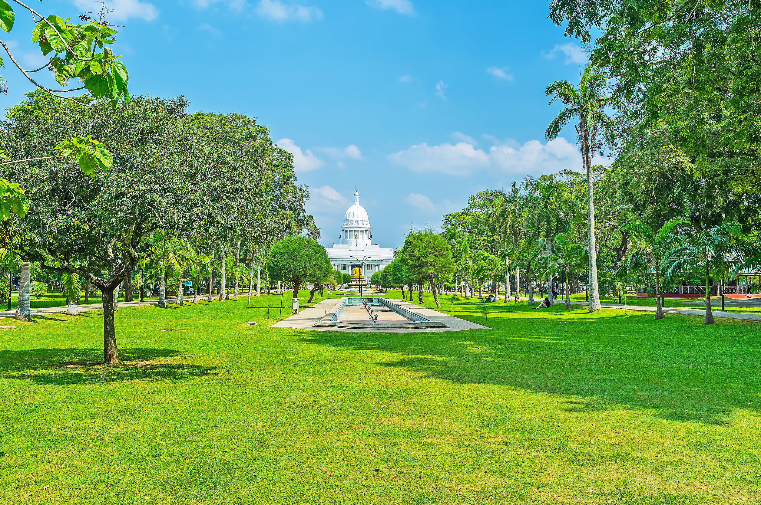 central alley of viharamahadevi park faces the huge white colonial style building of the town