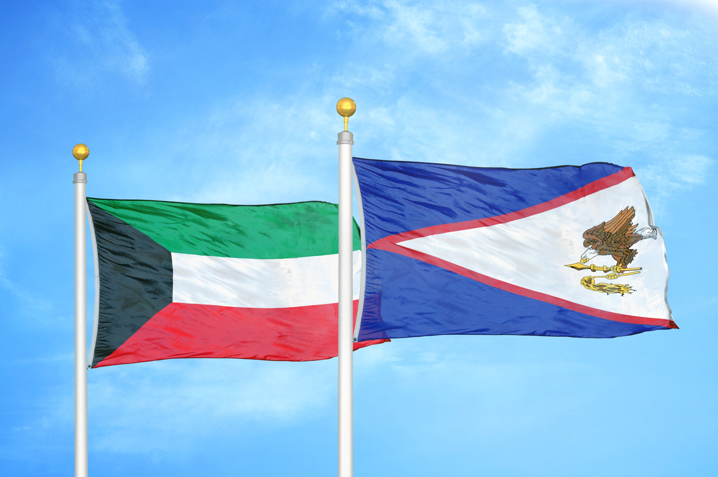 Kuwait And American Samoa Two Flags On Flagpoles And Blue Cloudy