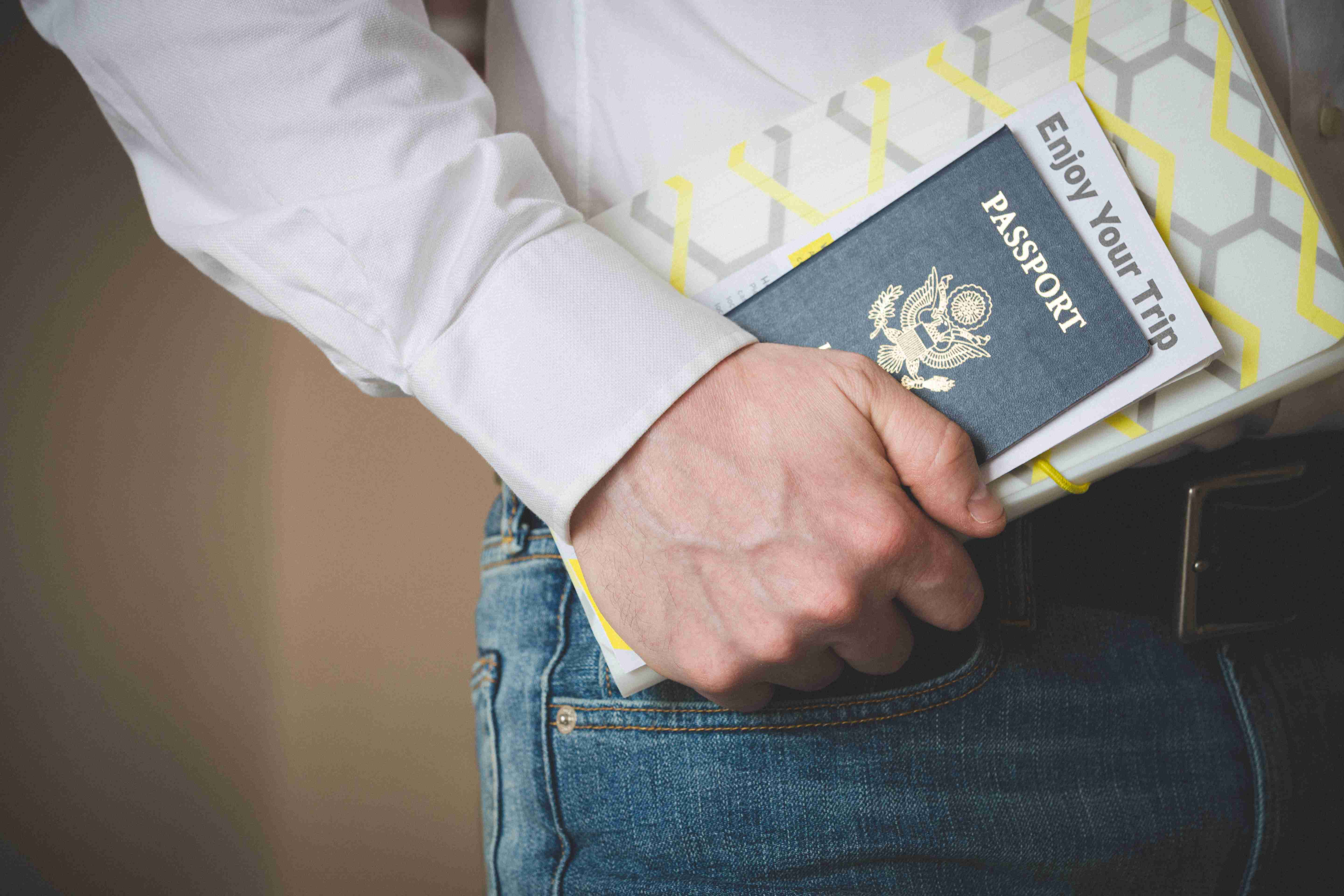 Passport In The Hand Of A Young Man Passport And Travel Documents Waiting For A Flight